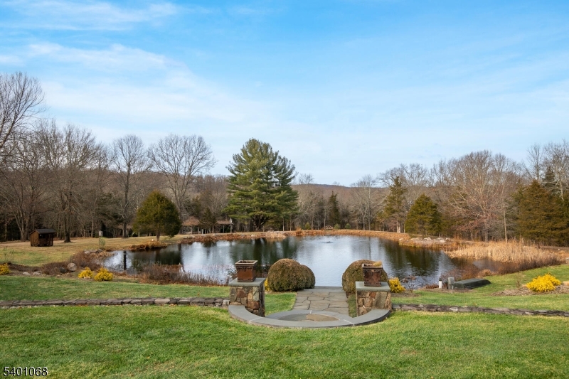 581 Pottersville Road Bedminster, NJ 07931 - Photo 13 of 50 a backyard of a house with table and chairs
