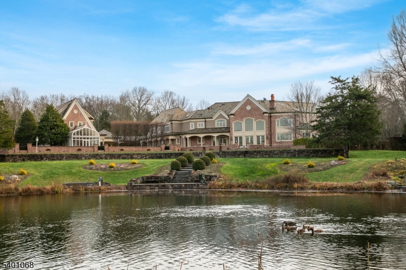581 Pottersville Road Bedminster, NJ 07931 - Photo 14 of 50 a view of a lake with a big yard and large trees