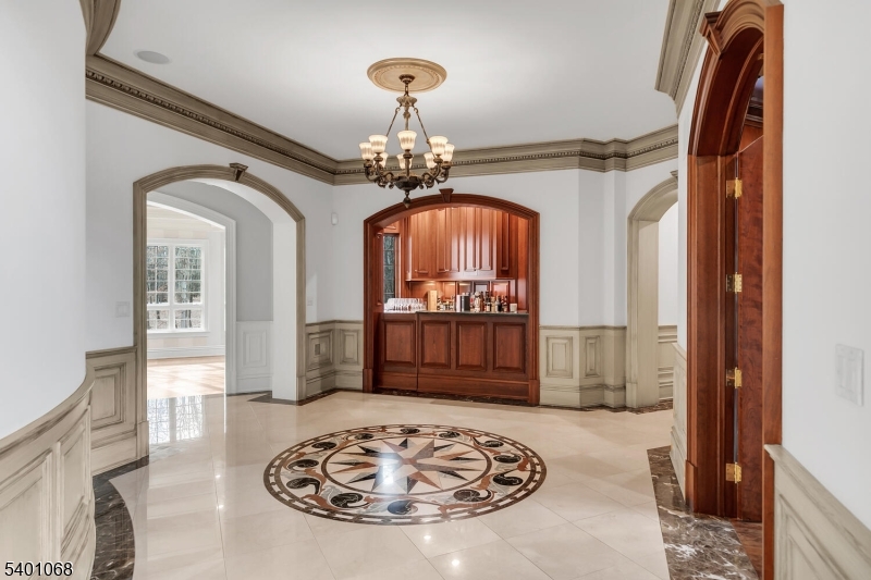 581 Pottersville Road Bedminster, NJ 07931 - Photo 22 of 50 a view of a hallway with wooden floor and a chandelier