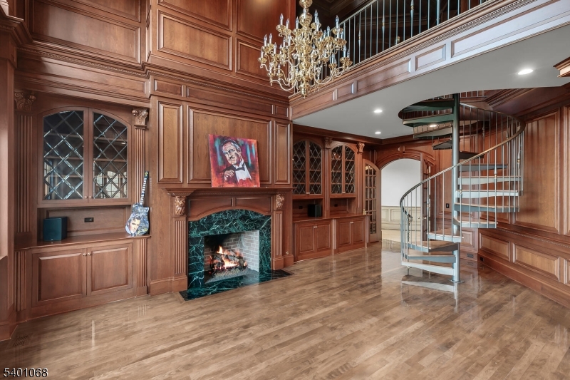581 Pottersville Road Bedminster, NJ 07931 - Photo 25 of 50 a view of an empty room with wooden floor fireplace and windows