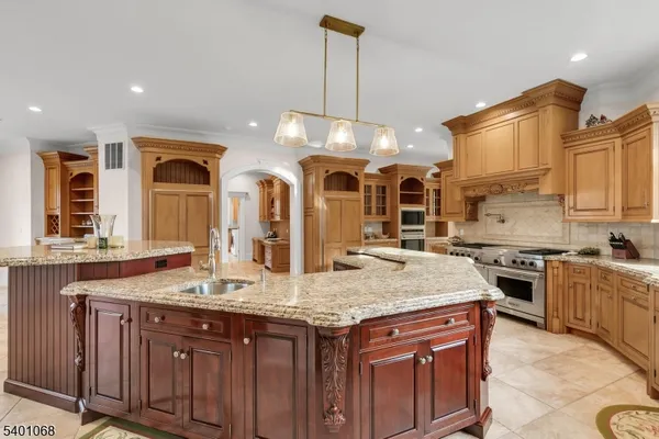 a kitchen with granite countertop a sink stove and cabinets