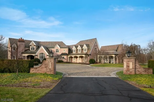 a view of a big house with a big yard and large tree