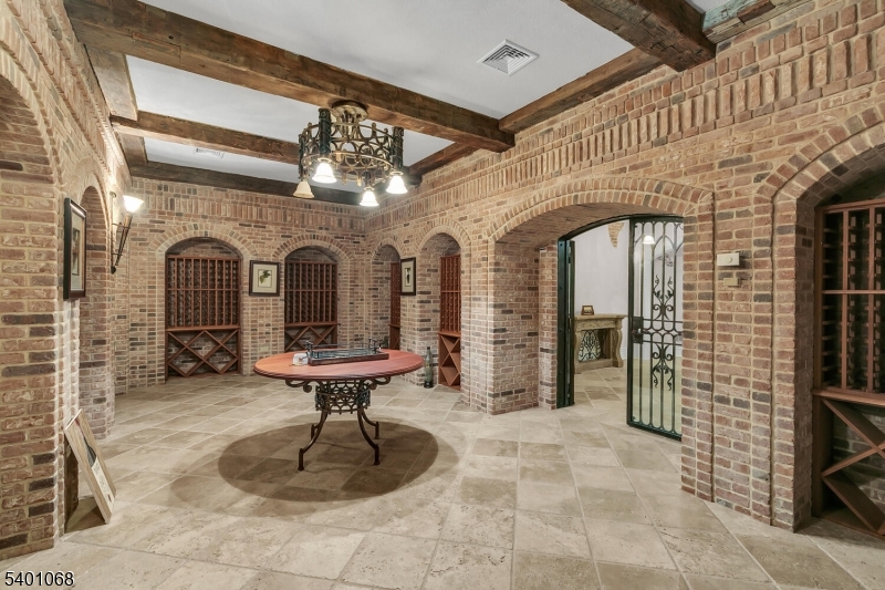 581 Pottersville Road Bedminster, NJ 07931 - Photo 41 of 50 a view of a hallway with a chandelier and fireplace