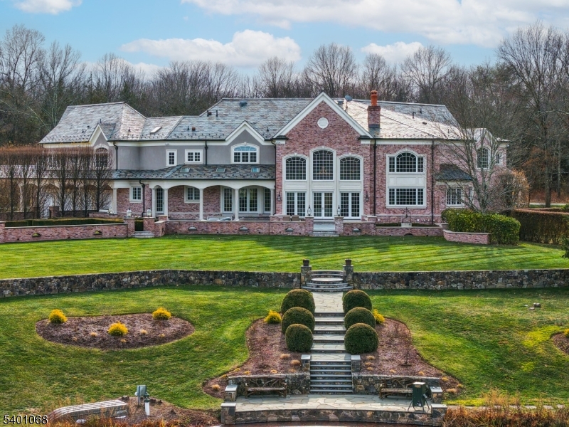 581 Pottersville Road Bedminster, NJ 07931 - Photo 43 of 50 a front view of a house with a yard table and chairs