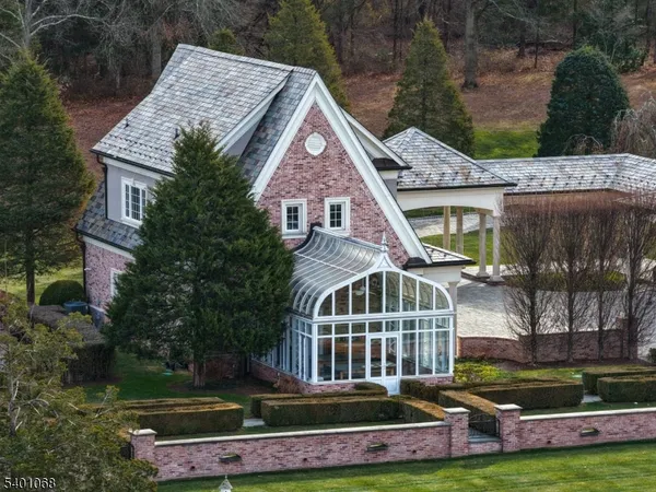 a aerial view of a house with swimming pool and a yard