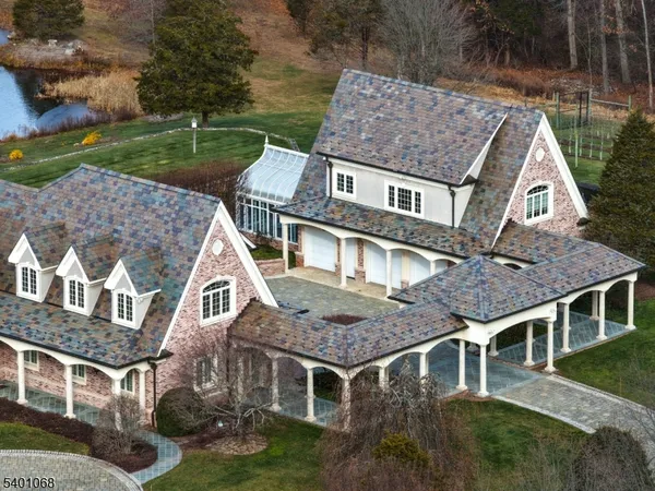 an aerial view of a house with yard and mountain view