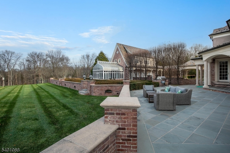 581 Pottersville Road Bedminster, NJ 07931 - Photo 9 of 50 a view of a patio with couches potted plants and lake view