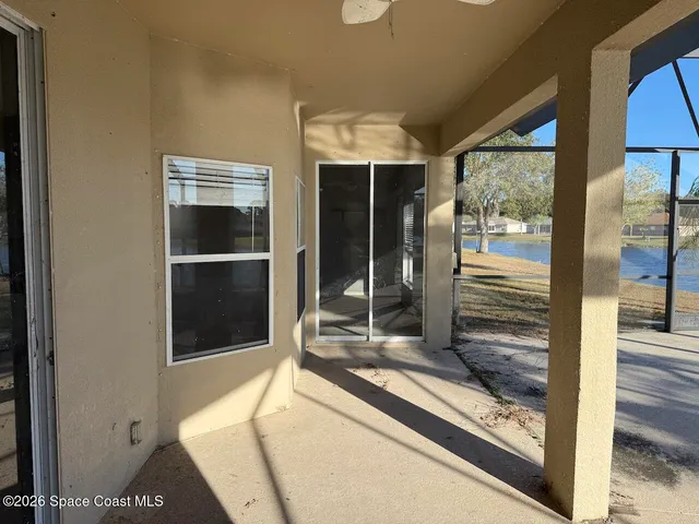 a living room with a large window and furniture