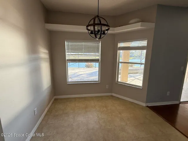 a room with window and a chandelier