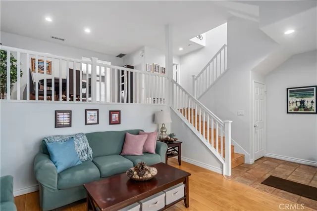 a living room with furniture and stairs