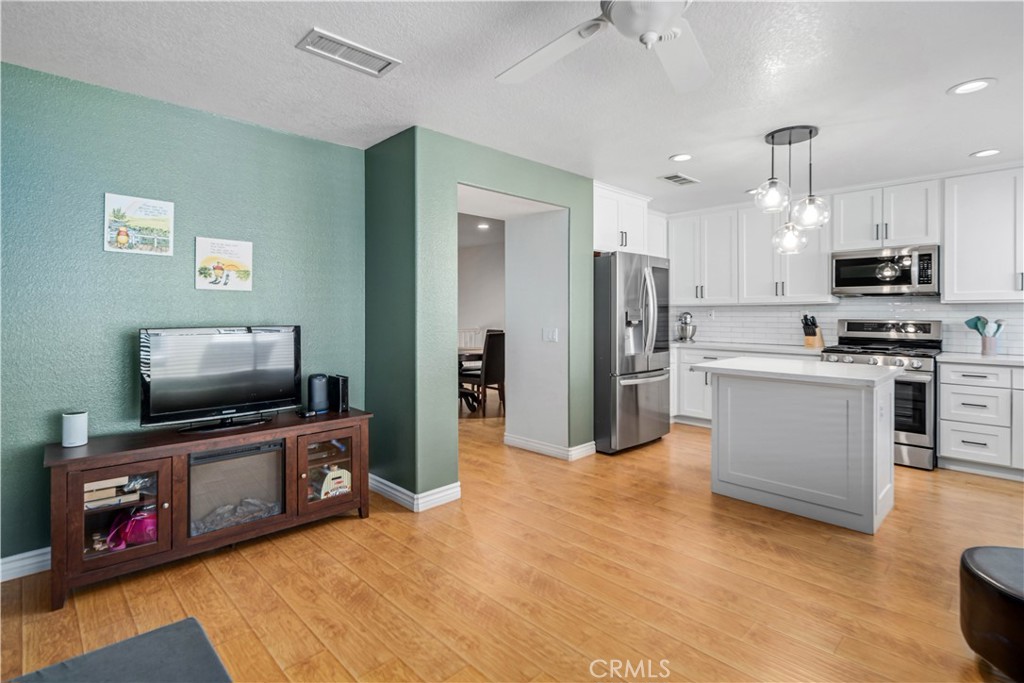 25710 Wagner Way, Unit C Stevenson Ranch, CA 91381 - Photo 16 of 37 a living room with stainless steel appliances furniture and a flat screen tv