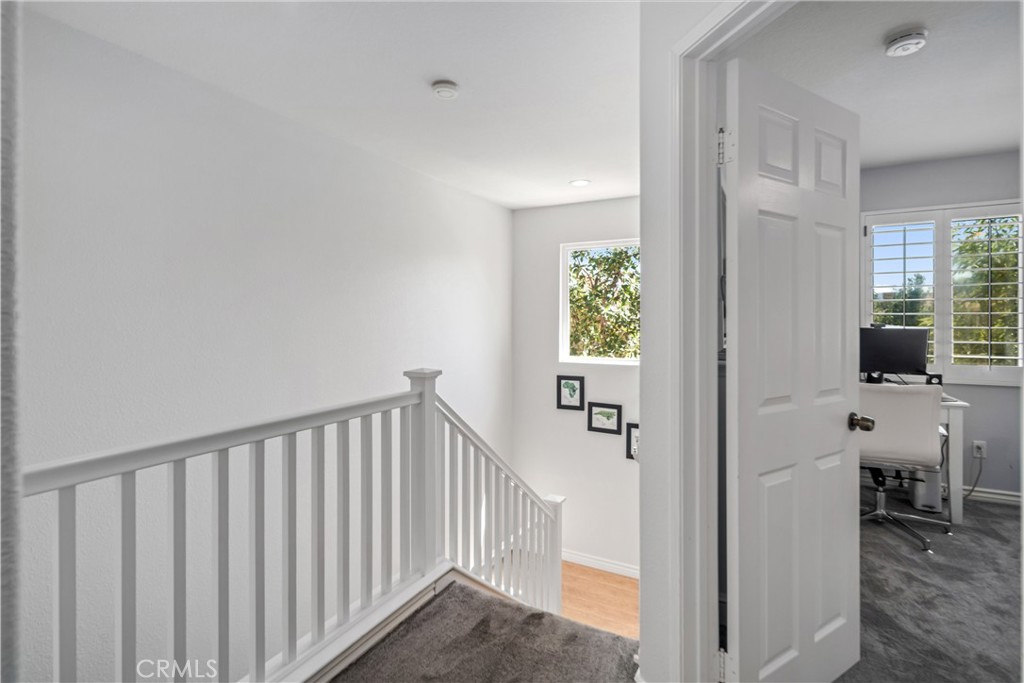 25710 Wagner Way, Unit C Stevenson Ranch, CA 91381 - Photo 19 of 37 a view of a hallway with dining room and stairs