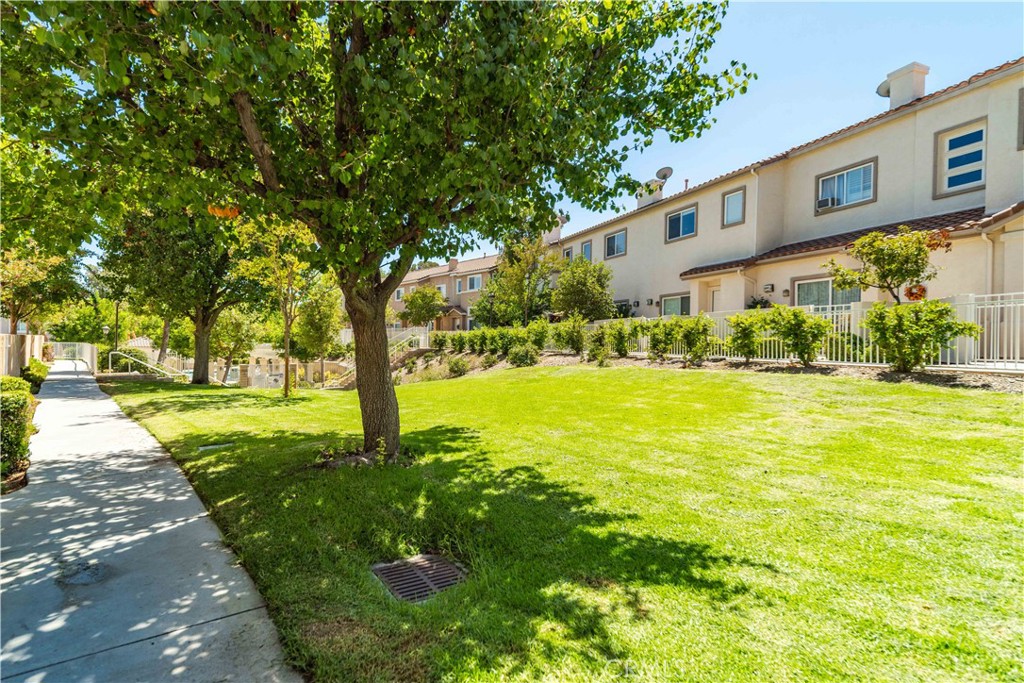 25710 Wagner Way, Unit C Stevenson Ranch, CA 91381 - Photo 2 of 37 a view of a yard with plants and trees