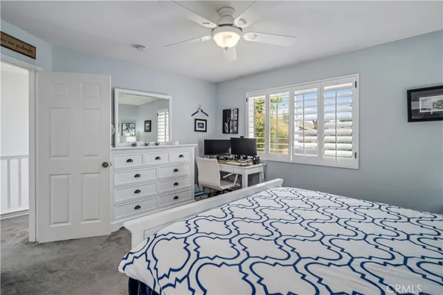 a bedroom with bed and a window