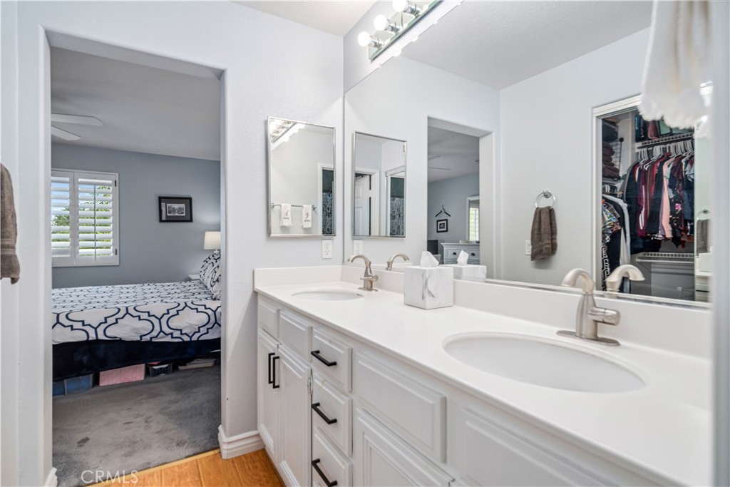 25710 Wagner Way, Unit C Stevenson Ranch, CA 91381 - Photo 23 of 37 a en suite bathroom with double sink and a mirror