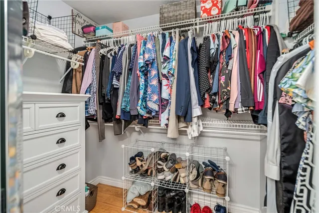a view of walk in closet with clothes