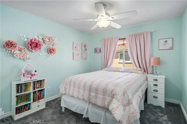 a bedroom with a bed and a book shelf