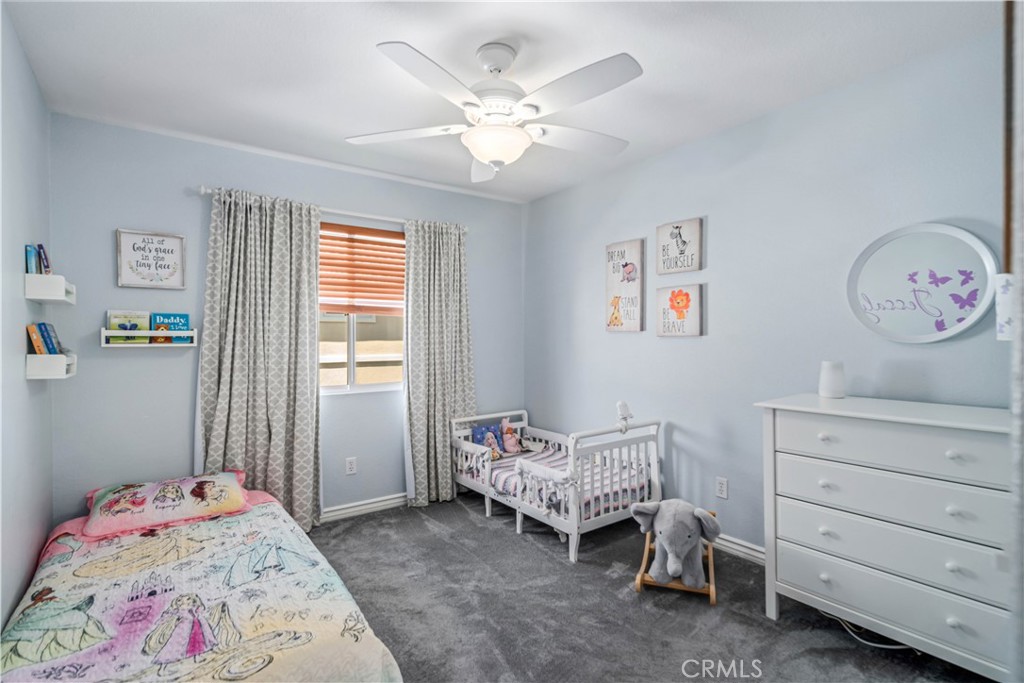 25710 Wagner Way, Unit C Stevenson Ranch, CA 91381 - Photo 26 of 37 a bedroom with a bed and a chandelier