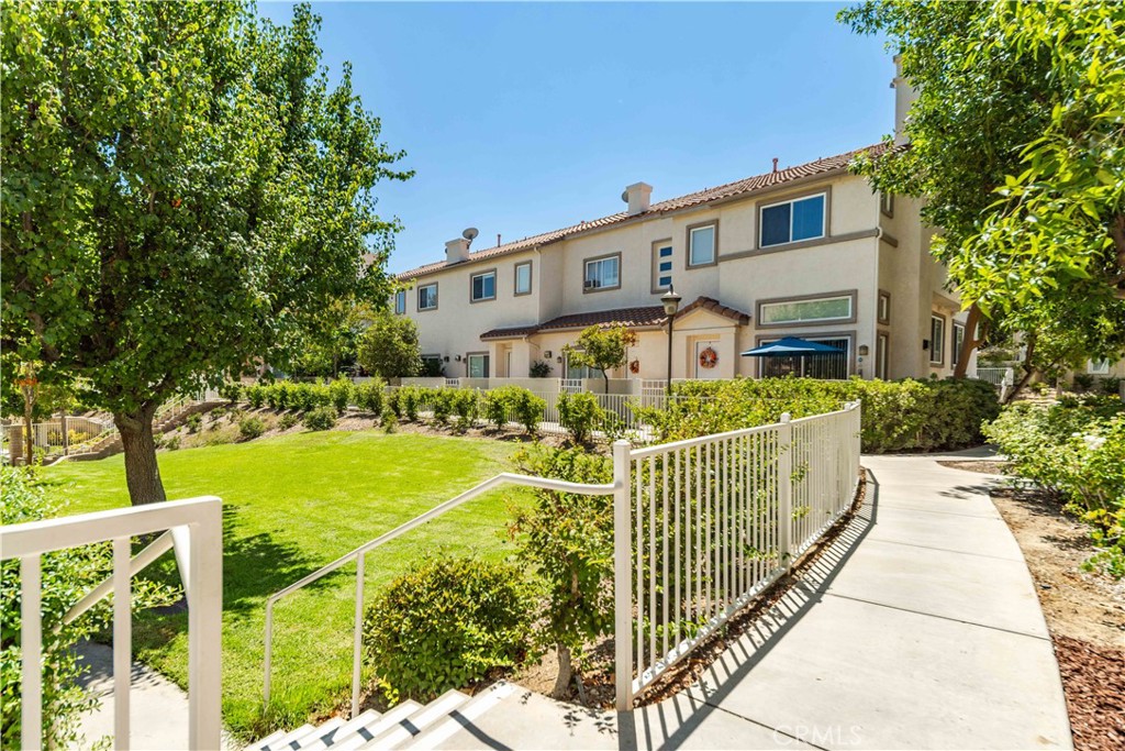 25710 Wagner Way, Unit C Stevenson Ranch, CA 91381 - Photo 30 of 37 a front view of a house with garden