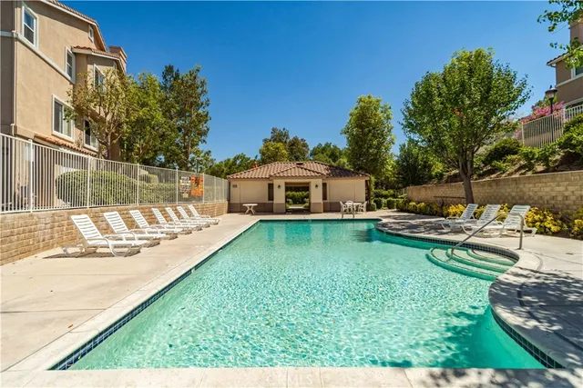 a view of a house with backyard sitting area and garden