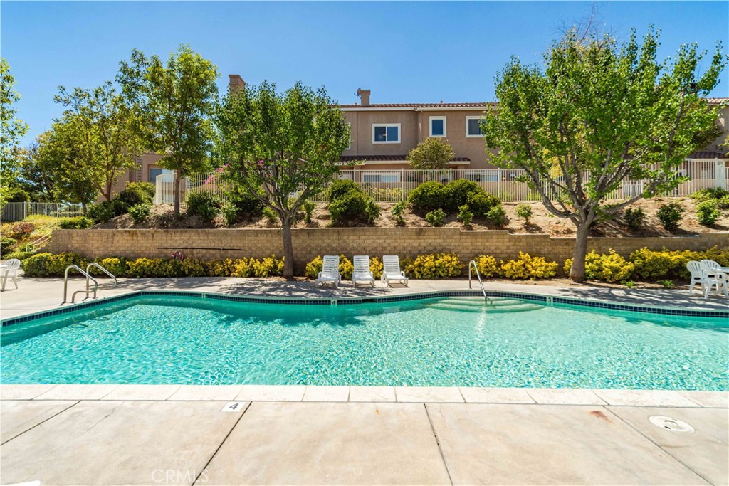 25710 Wagner Way, Unit C Stevenson Ranch, CA 91381 - Photo 33 of 37 a view of a big house with a big yard and potted plants