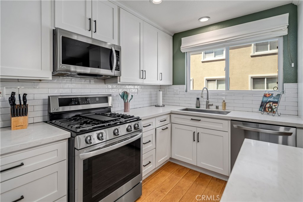 25710 Wagner Way, Unit C Stevenson Ranch, CA 91381 - Photo 9 of 37 a kitchen with a stove a sink and a microwave