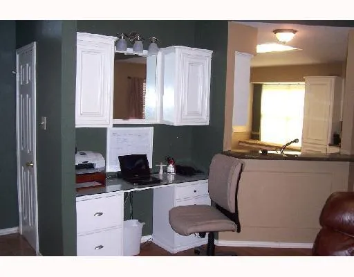 a kitchen with a refrigerator and a stove