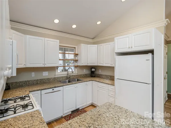 a kitchen with a sink stove and refrigerator