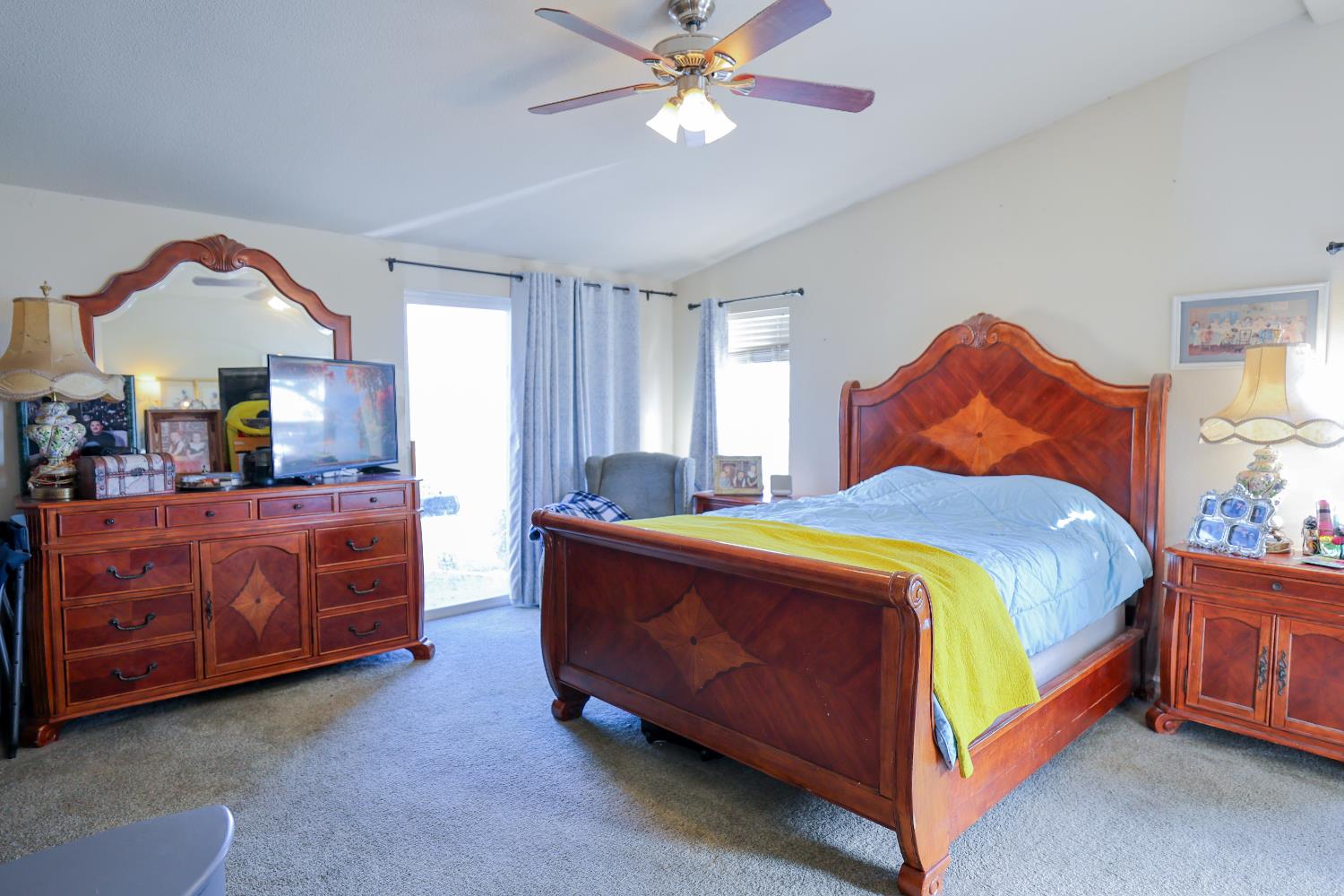 124 Wyer Road Arbuckle, CA 95912 - Photo 15 of 43 a bedroom with a bed and a chandelier