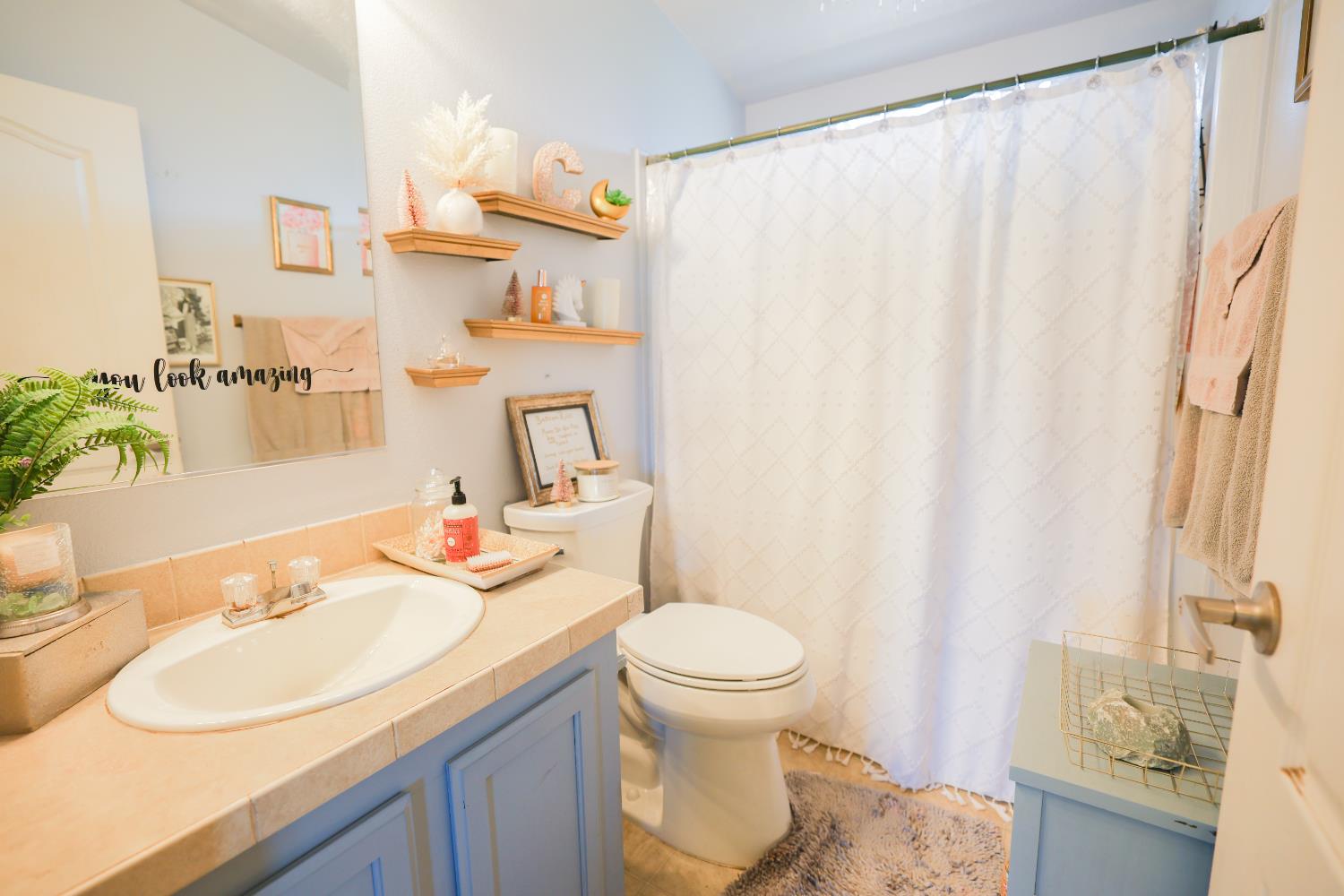 124 Wyer Road Arbuckle, CA 95912 - Photo 21 of 43 a bathroom with a sink vanity mirror and toilet