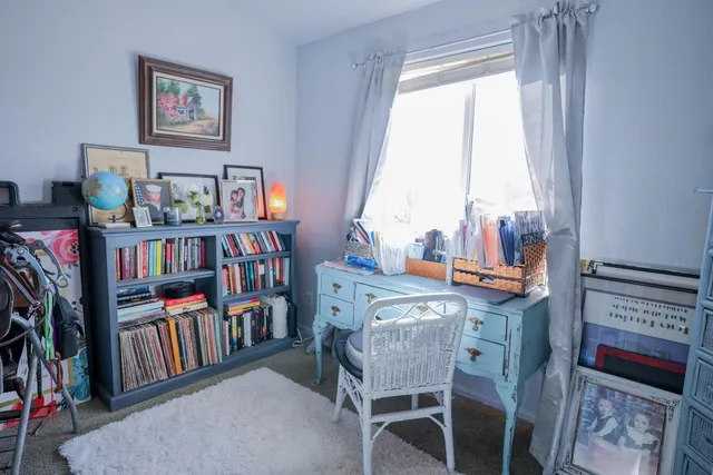 a view of an empty room with closet and windows