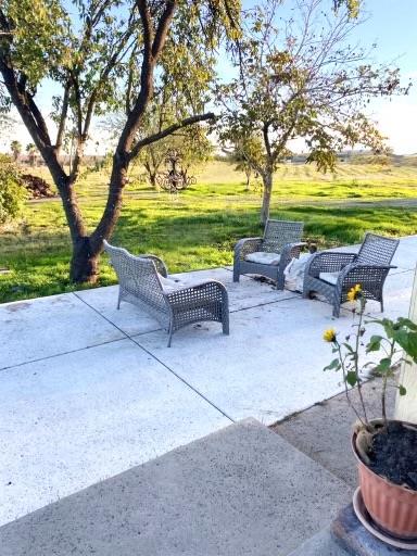 124 Wyer Road Arbuckle, CA 95912 - Photo 29 of 43 a view of a patio with lawn chairs under a large tree