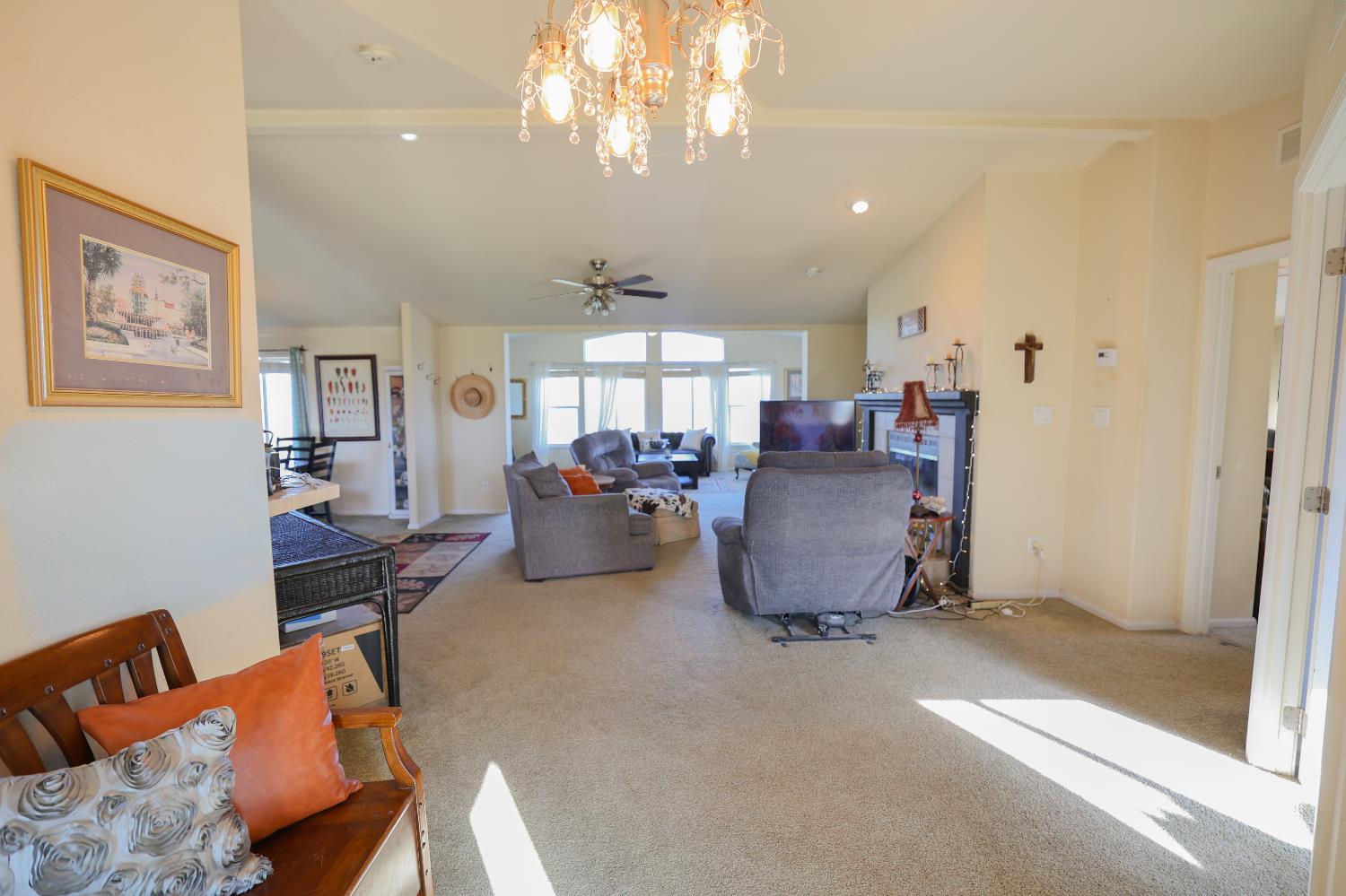 124 Wyer Road Arbuckle, CA 95912 - Photo 10 of 43 a living room with furniture and a chandelier