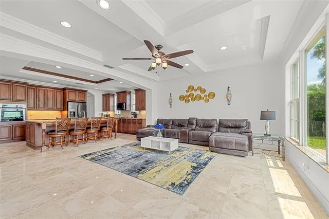 a kitchen with stainless steel appliances kitchen island granite countertop a table chairs sink and cabinets