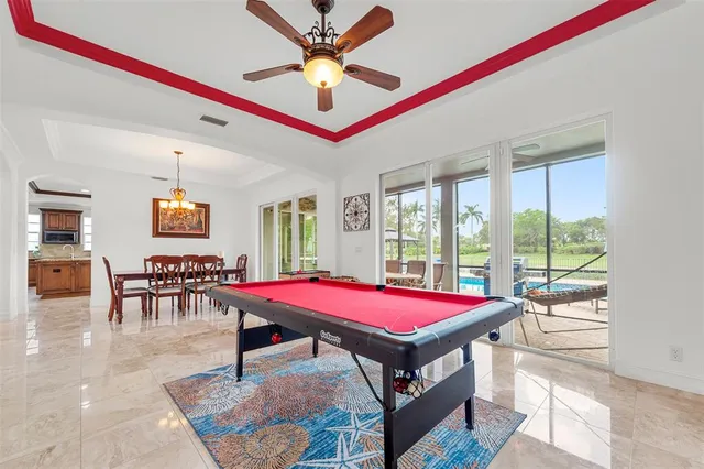 a dining room with furniture a chandelier and window