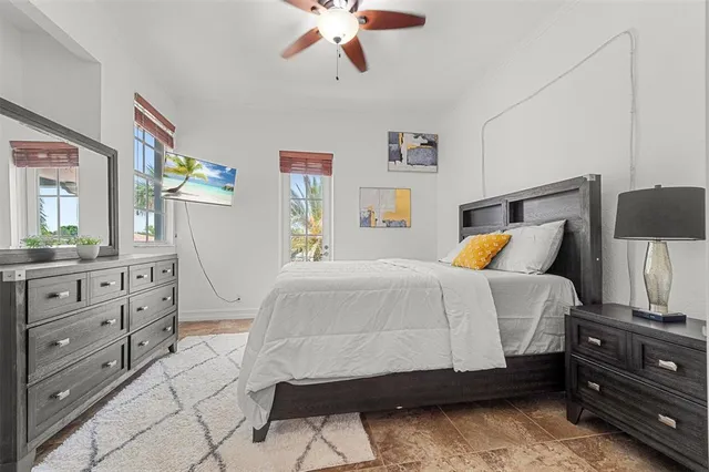a bedroom with a bed and a chandelier