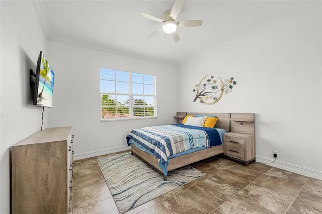 a bedroom with a bed a couch and a chandelier