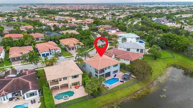 an aerial view of residential houses with outdoor space and parking
