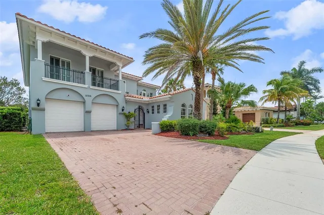 a front view of a house with a yard and a garage