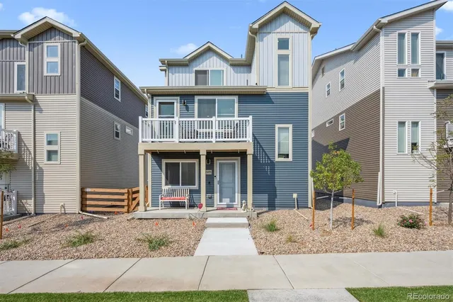 a front view of a house with glass windows and refrigerator
