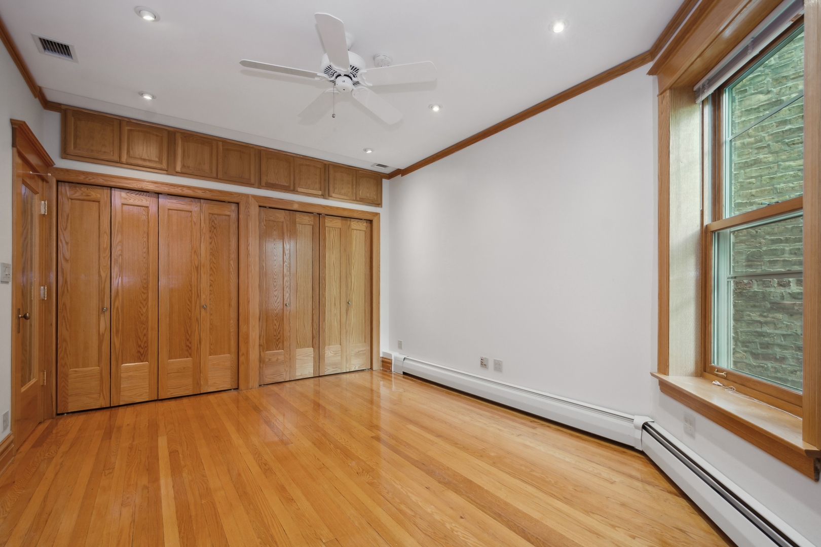 3631 North Sheffield Avenue, Unit 2 Chicago, IL 60613 - Photo 14 of 23 a view of an empty room with a window and wooden floor