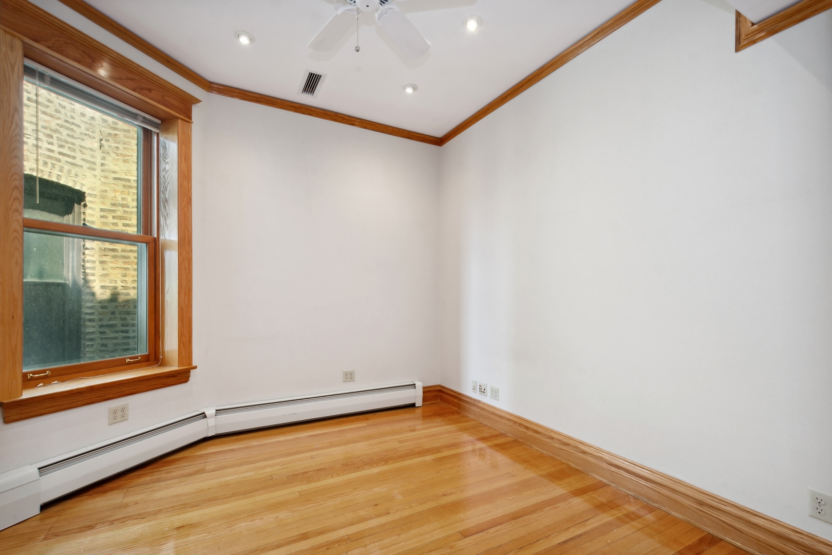 3631 North Sheffield Avenue, Unit 2 Chicago, IL 60613 - Photo 16 of 23 a view of an empty room with wooden floor and a window