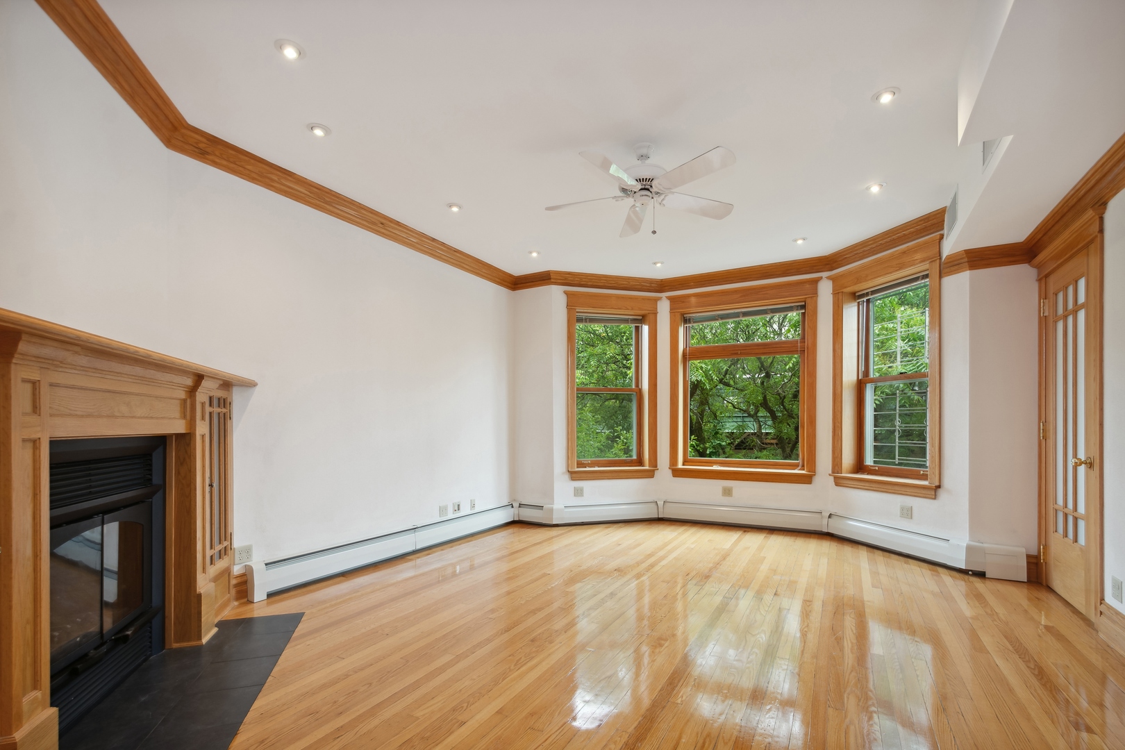3631 North Sheffield Avenue, Unit 2 Chicago, IL 60613 - Photo 2 of 23 a view of an empty room with a window and wooden floor