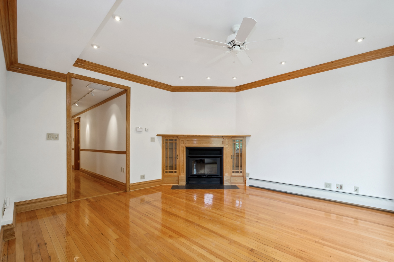 3631 North Sheffield Avenue, Unit 2 Chicago, IL 60613 - Photo 3 of 23 a view of an empty room with a fireplace and a window