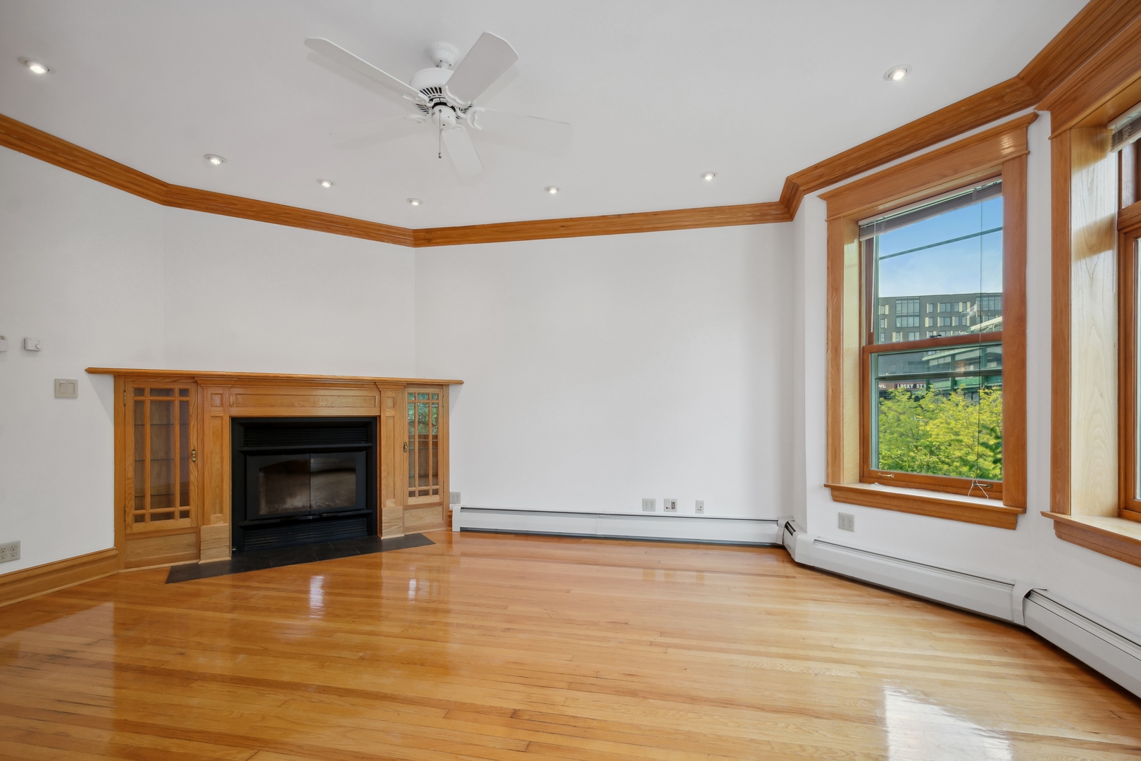 3631 North Sheffield Avenue, Unit 2 Chicago, IL 60613 - Photo 4 of 23 an empty room with windows and fireplace