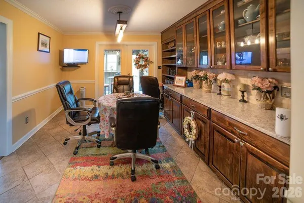 a dining room with furniture and window