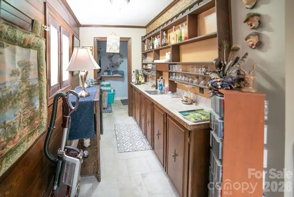 a kitchen with a sink and wooden floor