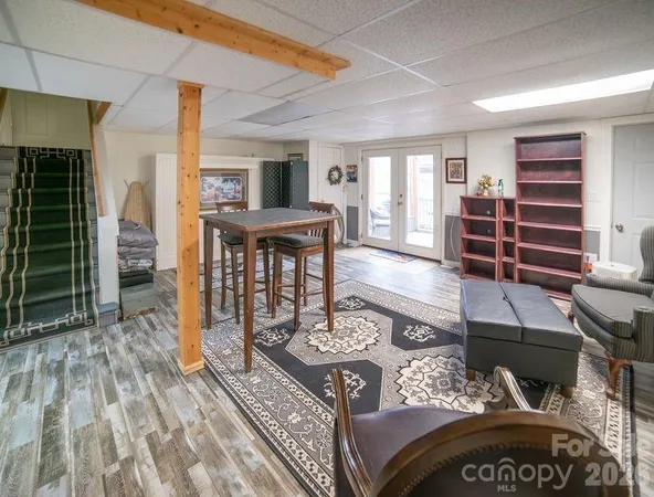 a living room with furniture and a glass door