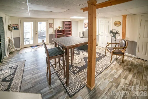 a view of a dining room with furniture a chandelier and wooden floor