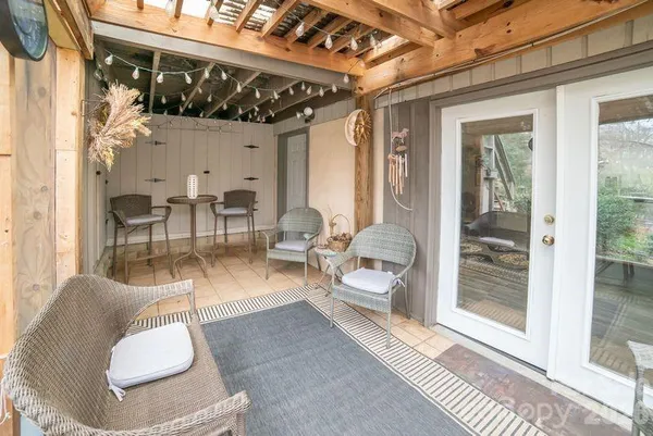 a view of a house with backyard and sitting area